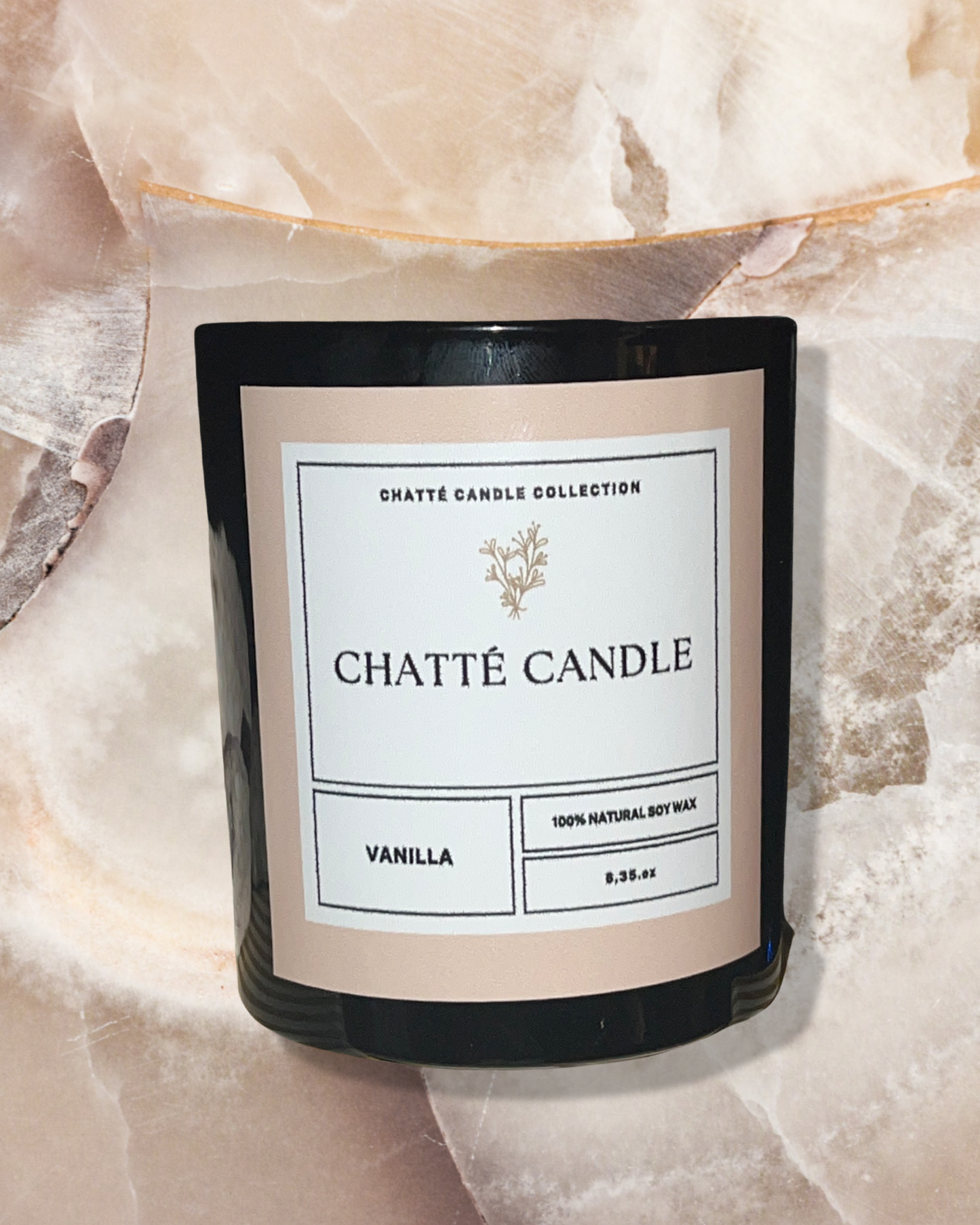 Vanilla Geur luxury scented candle in black glass vessel with minimalist label, featuring 100% natural soy wax, photographed on crystalline stone background - by Chatté Candles