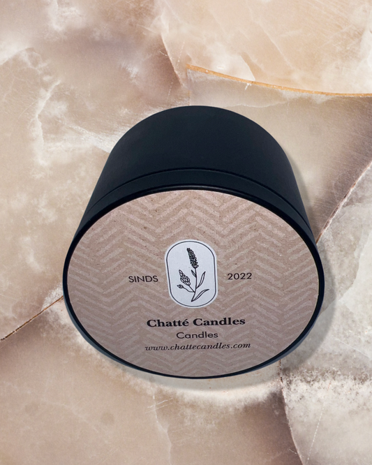 Elegant black candle container for Vanilla Geur fragrance, featuring a tan label with chevron pattern and botanical logo design, photographed on marble surface. Premium home fragrance by Chatté Candles, established since 2022.