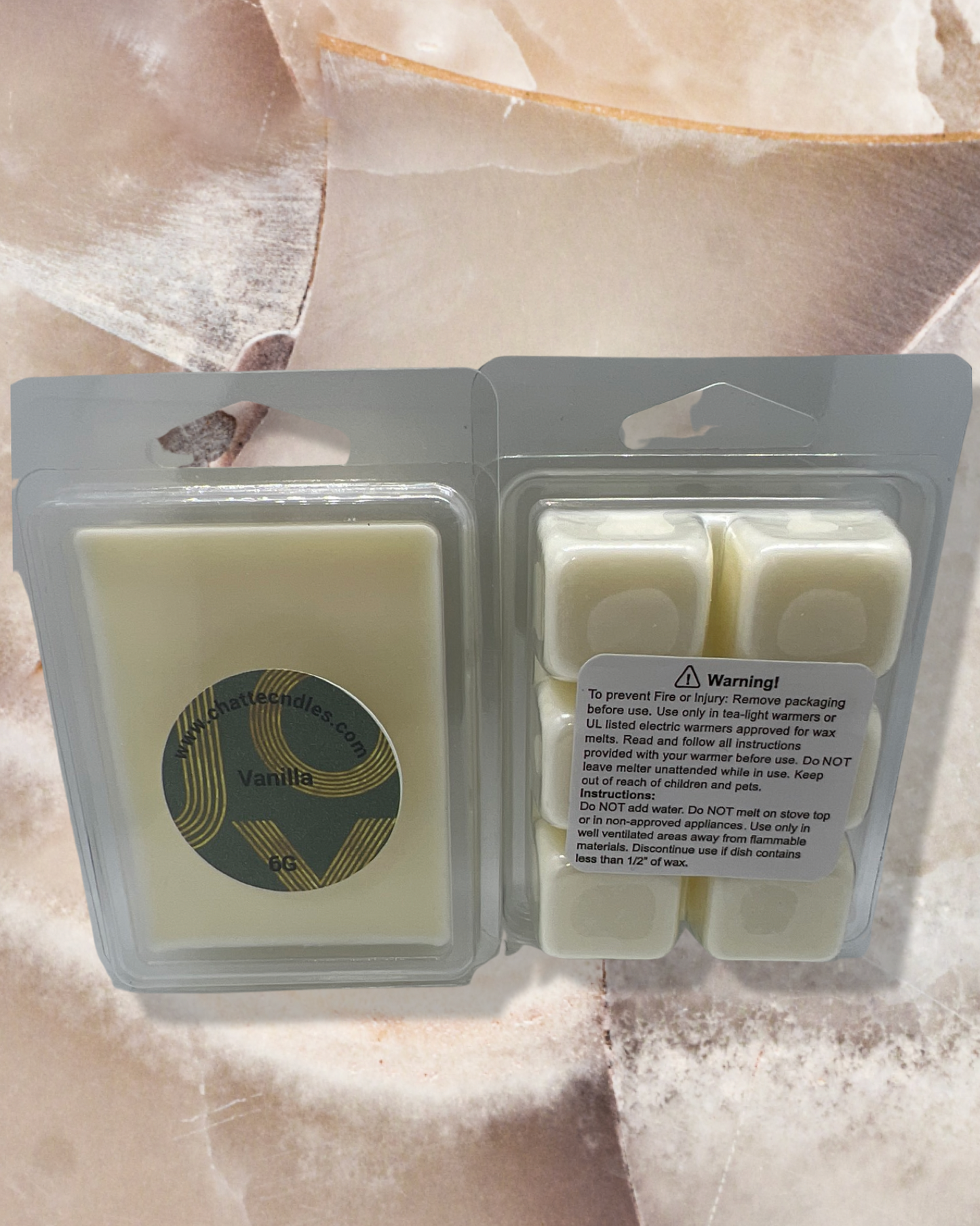 Vanilla Geur wax melts in creamy white color, packaged in clear plastic clamshell containers. Features elegant circular label with gold accents. Perfect for creating a warm, comforting atmosphere in any room. By Chatté Candles