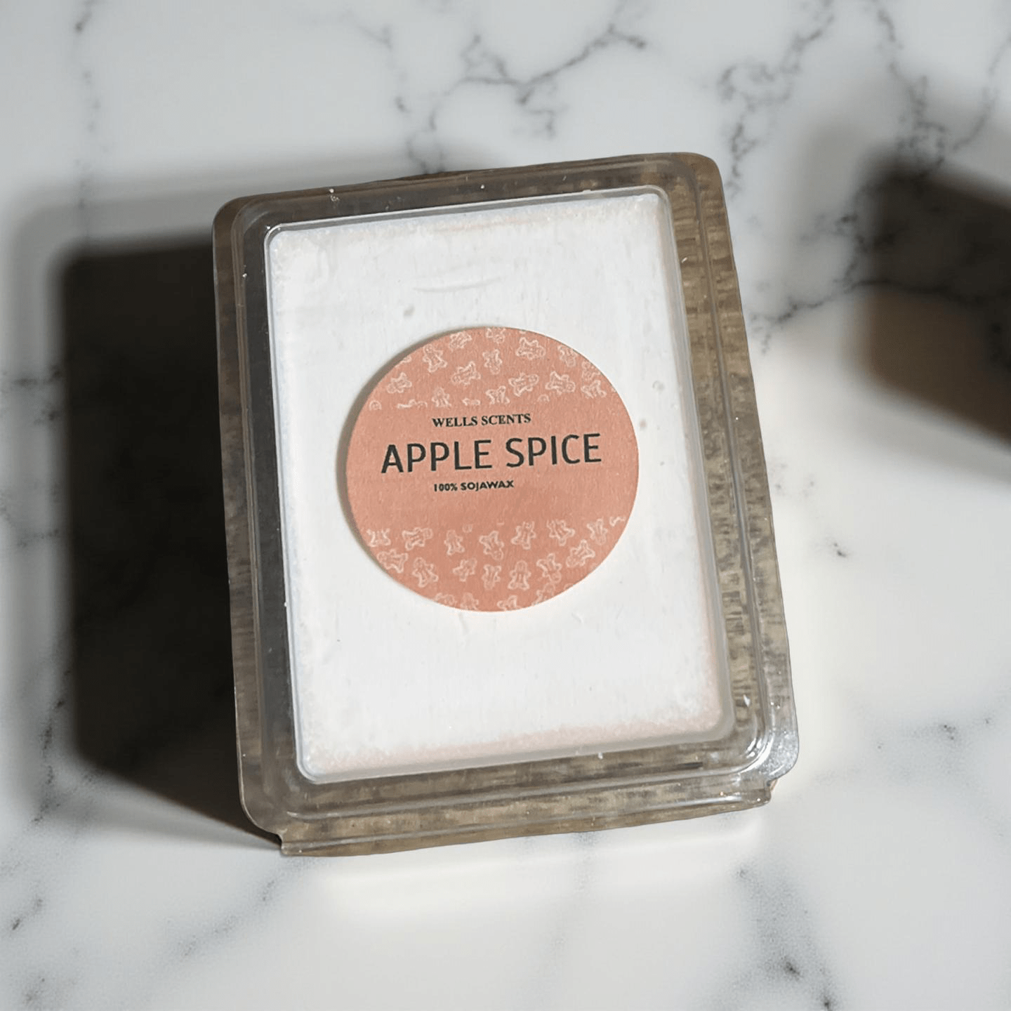 Apple Spice scented wax melts in clear clamshell packaging with peach label, 100% soy wax by Chatté Candles.