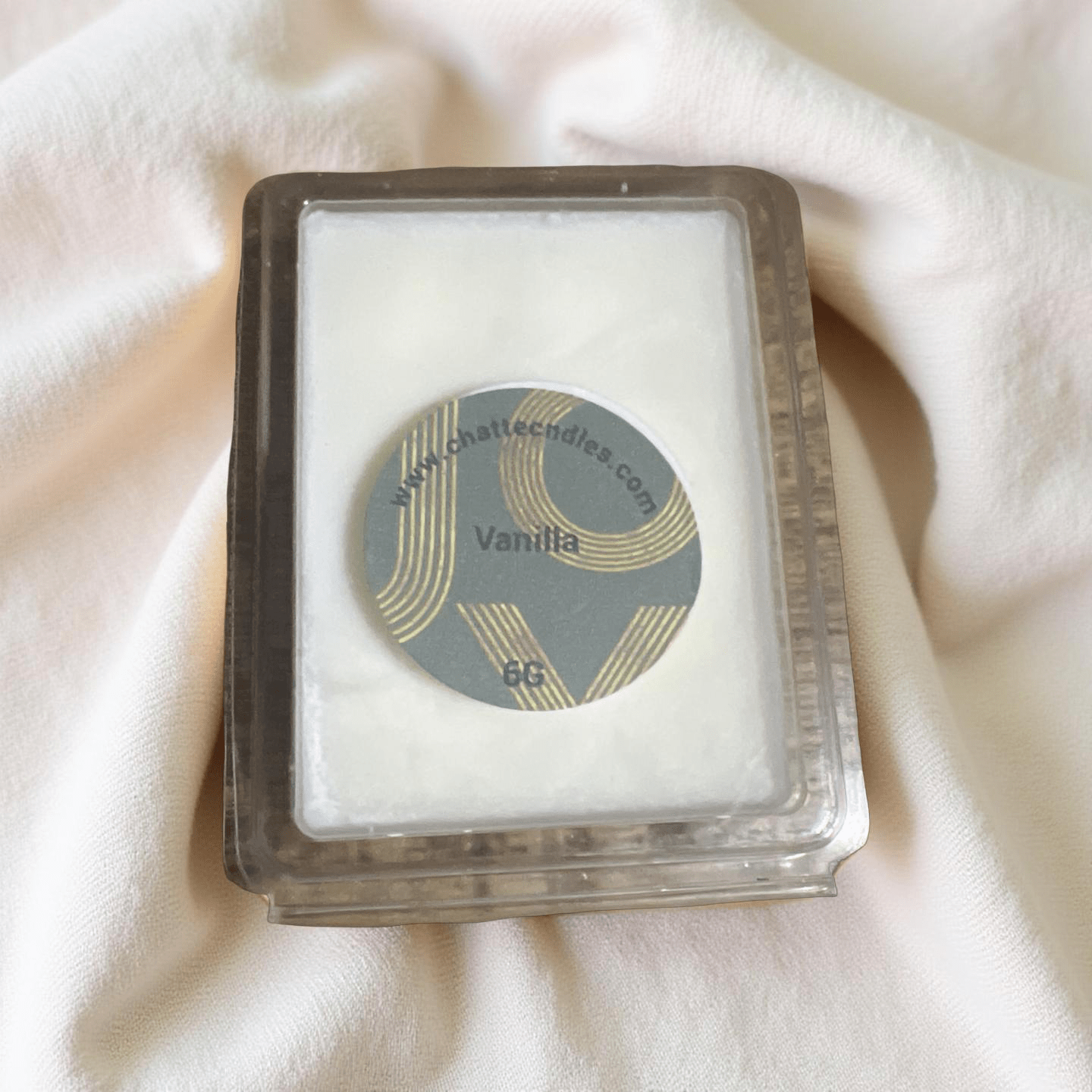 Vanilla wax melts in clear clamshell packaging with gray and gold label, by Chatté Candles Ice Cream collection