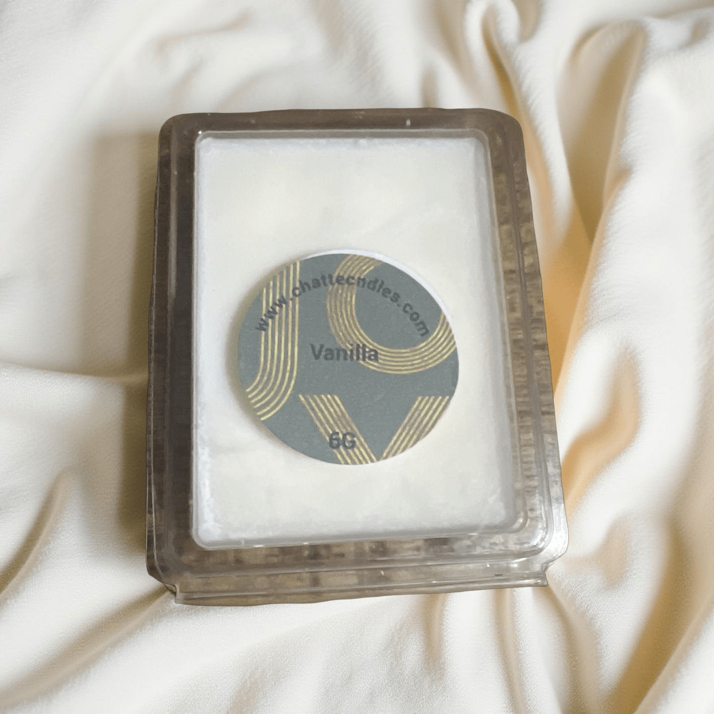 Vanilla scented wax melts in clear clamshell with gold-accented circular label by Chatté Candles