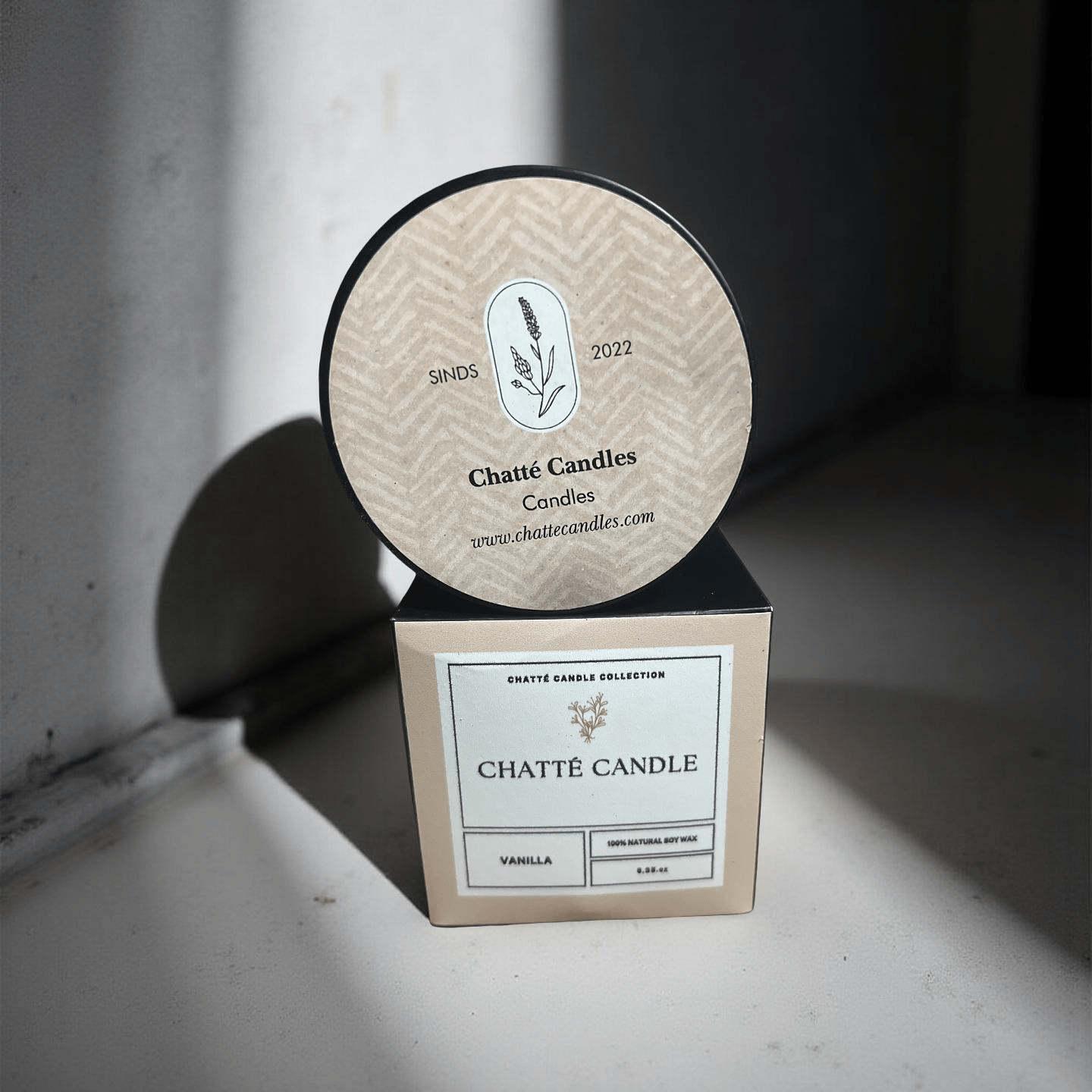 Vanilla Candle by Chatté Candles in beige packaging with botanical logo, photographed in natural light on neutral background